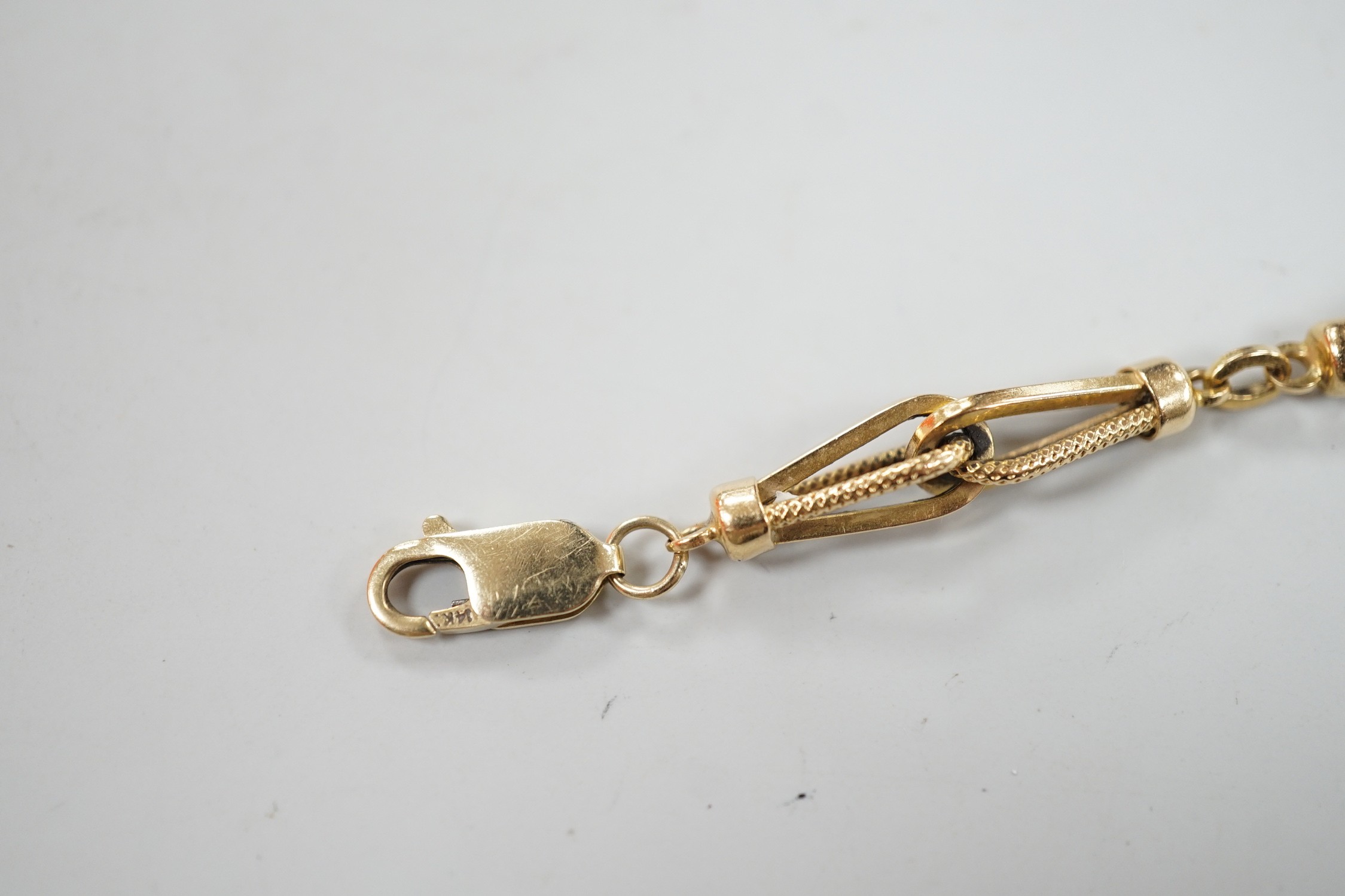 An 18k yellow metal fancy link bracelet with 14k clasp, 21cm, 10.7 grams.